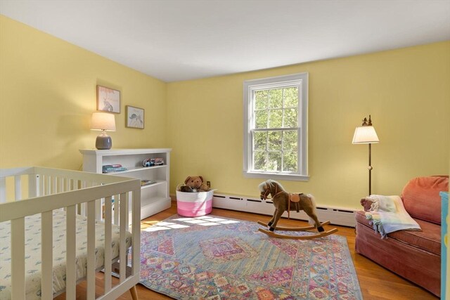 1395 Canton Ave, Milton, MA 02186 - bedroom with wood finished floors and a baseboard heating unit