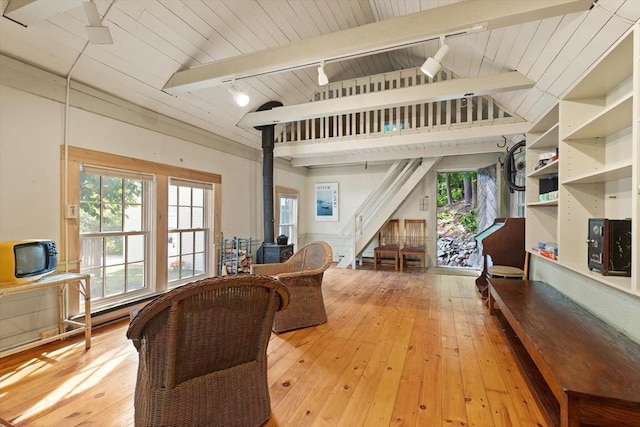 1395 Canton Ave, Milton, MA 02186 - living room with rail lighting, a wood stove, light wood finished floors, wood ceiling, and stairs