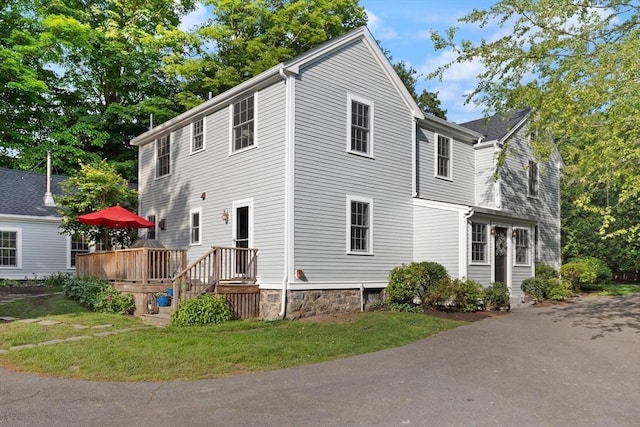 1395 Canton Ave, Milton, MA 02186 - view of front of house featuring a deck and a front lawn