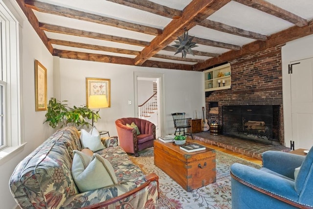 1395 Canton Ave, Milton, MA 02186 - living area with stairway, beam ceiling, a brick fireplace, and ceiling fan