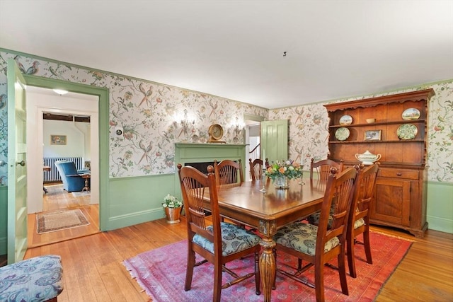 1395 Canton Ave, Milton, MA 02186 - dining space with wallpapered walls, a wainscoted wall, light wood finished floors, and radiator heating unit