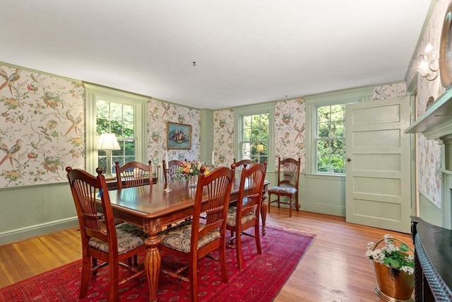 1395 Canton Ave, Milton, MA 02186 - dining room featuring wallpapered walls, light wood-style flooring, and a wainscoted wall