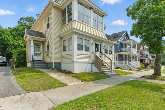 31-33 Beauchamp St, Springfield, MA 01107 - view of front of home featuring entry steps, a front lawn, and cooling unit