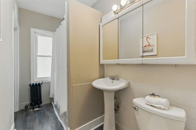 31-33 Beauchamp St, Springfield, MA 01107 - full bath featuring radiator heating unit, toilet, wood finished floors, baseboards, and a shower with shower curtain