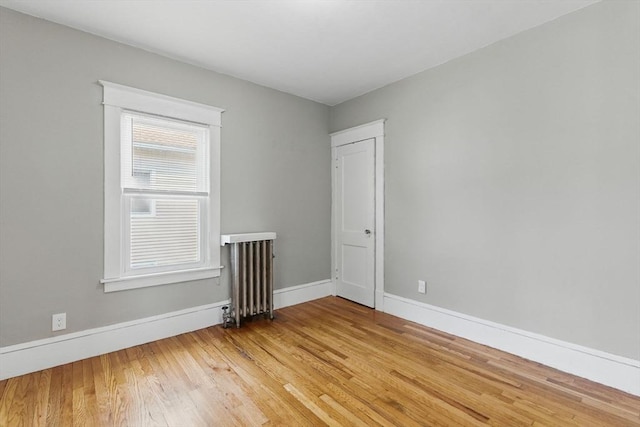 31-33 Beauchamp St, Springfield, MA 01107 - empty room with radiator, baseboards, and light wood finished floors