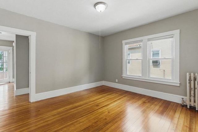 31-33 Beauchamp St, Springfield, MA 01107 - empty room with baseboards, hardwood / wood-style floors, and radiator heating unit