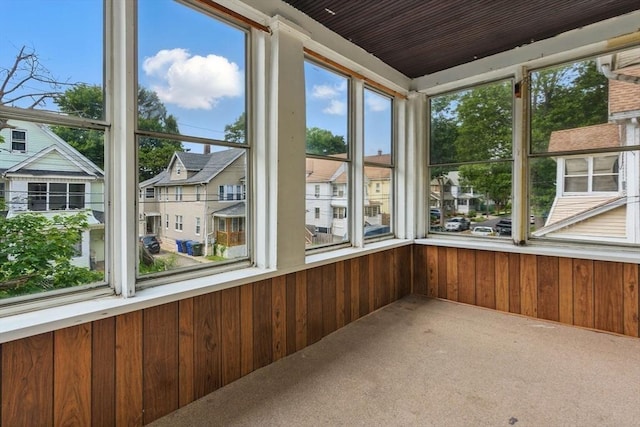 31-33 Beauchamp St, Springfield, MA 01107 - unfurnished sunroom with wood walls, healthy amount of natural light, carpet, and a residential view