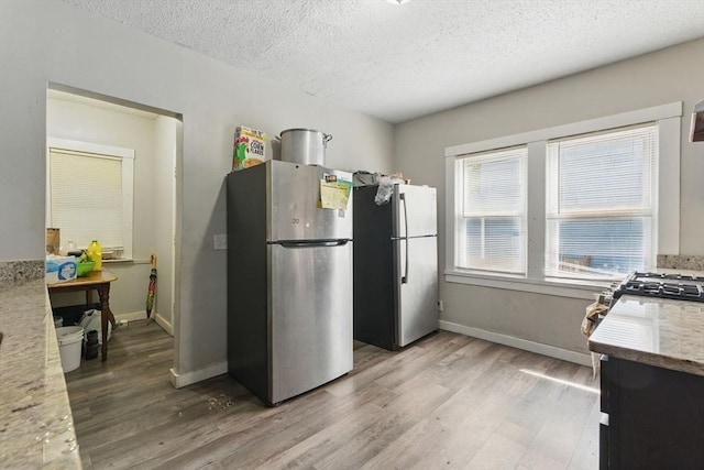 31-33 Beauchamp St, Springfield, MA 01107 - kitchen with freestanding refrigerator, light wood-style floors, a textured ceiling, and baseboards