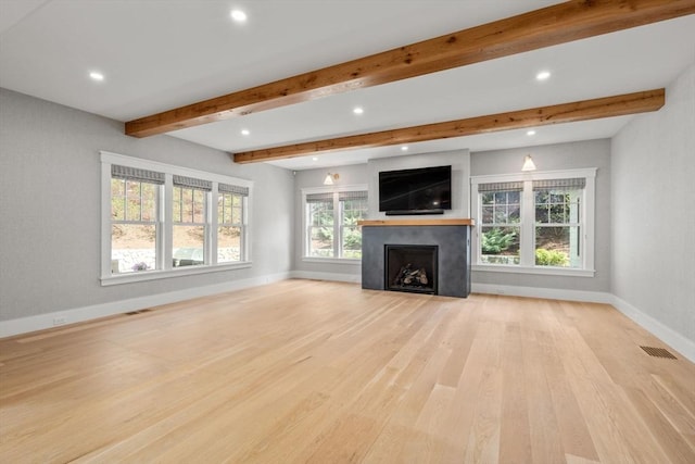 unfurnished living room featuring baseboards, light wood-type flooring, recessed lighting, and beam ceiling