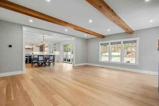 living area with a notable chandelier, recessed lighting, baseboards, light wood-type flooring, and beamed ceiling