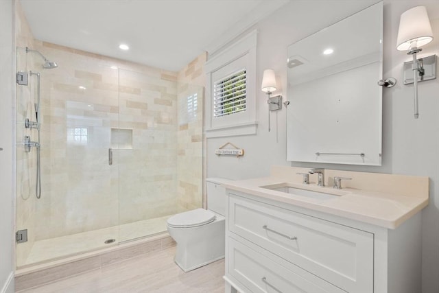 bathroom with vanity, toilet, recessed lighting, and a stall shower