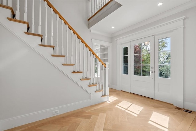 entryway with crown molding, stairs, recessed lighting, baseboards, and visible vents