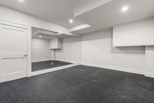 finished below grade area featuring baseboards and recessed lighting