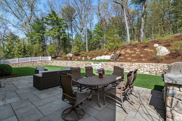 view of patio / terrace featuring fence and outdoor dining area