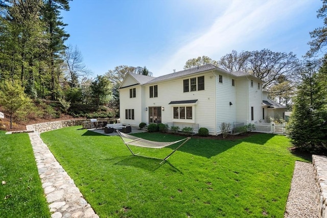 back of property featuring a yard, fence, an outdoor living space, and a patio area