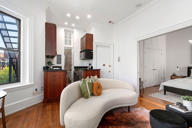 living room with hardwood / wood-style floors and crown molding