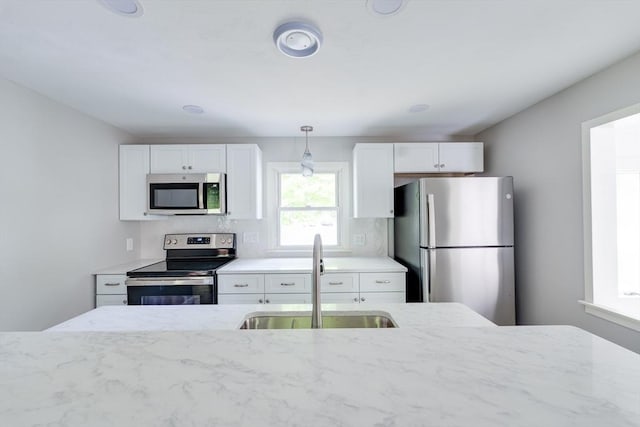 24 Harwich Rd, East Longmeadow, MA 01028 - kitchen with appliances with stainless steel finishes, a sink, light stone countertops, and white cabinets