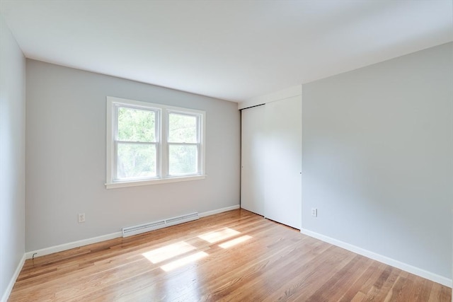 24 Harwich Rd, East Longmeadow, MA 01028 - spare room featuring baseboard heating, wood finished floors, and baseboards