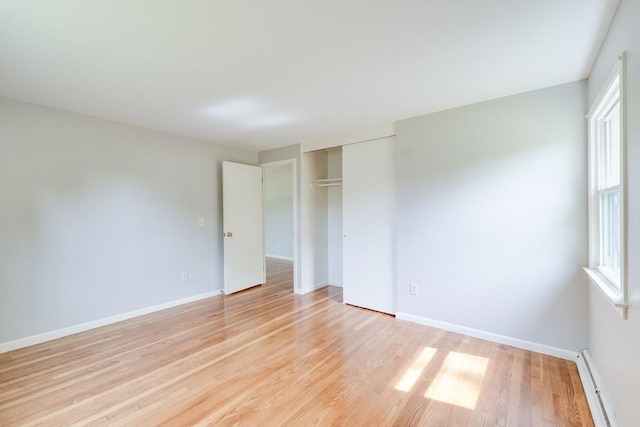 24 Harwich Rd, East Longmeadow, MA 01028 - unfurnished bedroom featuring baseboard heating, light wood-style flooring, baseboards, and a closet