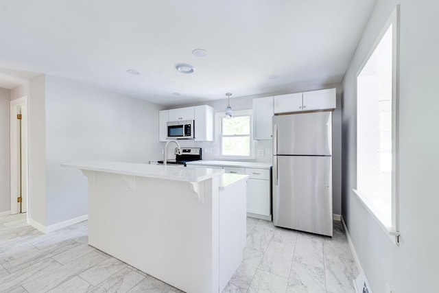 24 Harwich Rd, East Longmeadow, MA 01028 - kitchen featuring appliances with stainless steel finishes, light marble finish floors, light countertops, a kitchen bar, and white cabinets