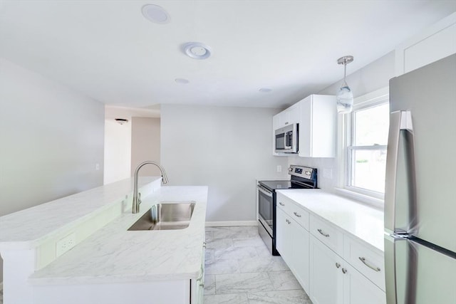24 Harwich Rd, East Longmeadow, MA 01028 - kitchen with appliances with stainless steel finishes, a sink, light marble finish floors, a center island with sink, and white cabinetry