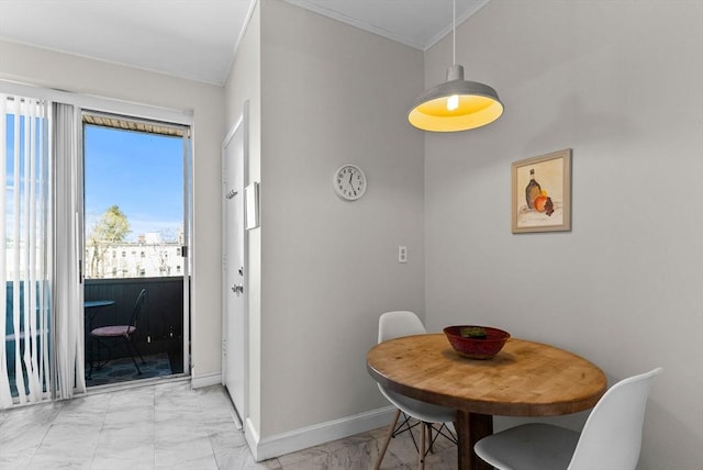 dining area featuring light marble finish flooring, baseboards, and ornamental molding