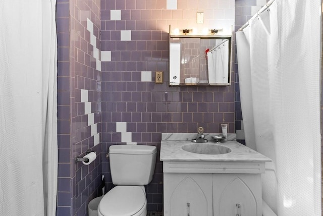 full bath featuring tile walls, toilet, and vanity