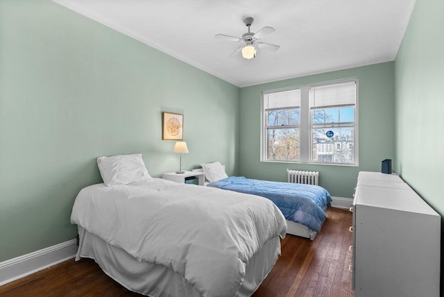 bedroom featuring radiator heating unit, baseboards, and dark wood-style floors
