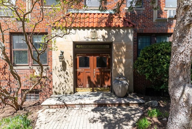view of exterior entry with brick siding