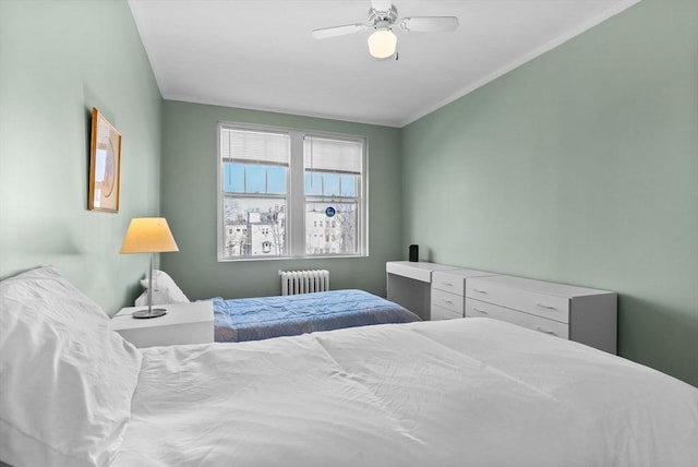bedroom with radiator heating unit and ceiling fan