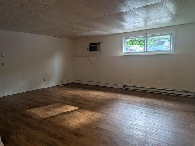 300 Smithfield Rd Unit 2-2, North Providence, RI 02904 - empty room featuring a baseboard radiator, dark wood-style floors, a wall mounted air conditioner, and a paneled ceiling
