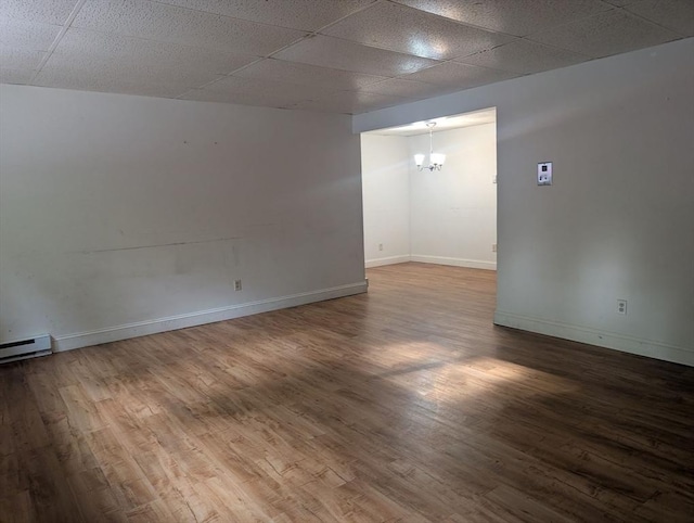 300 Smithfield Rd Unit 2-2, North Providence, RI 02904 - spare room featuring a chandelier, wood finished floors, a paneled ceiling, baseboards, and baseboard heating