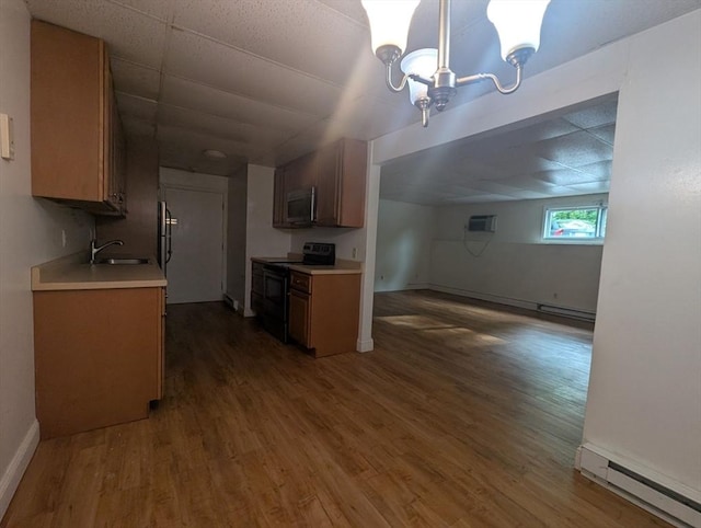 300 Smithfield Rd Unit 2-2, North Providence, RI 02904 - kitchen with black range with electric stovetop, stainless steel microwave, baseboard heating, wood finished floors, and light countertops