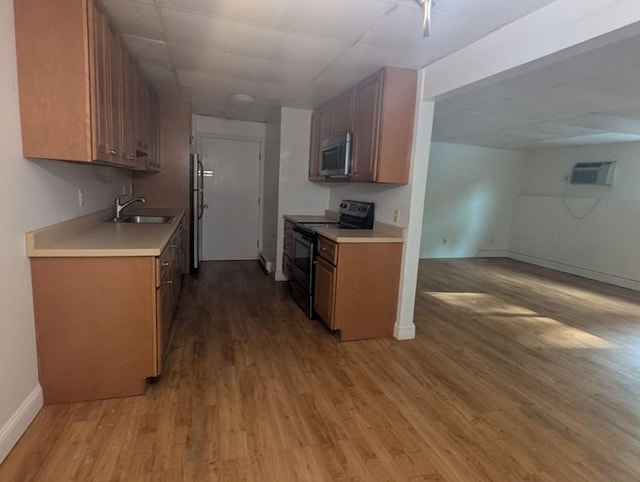 300 Smithfield Rd Unit 2-2, North Providence, RI 02904 - kitchen with electric stove, stainless steel microwave, a sink, and light wood-style flooring