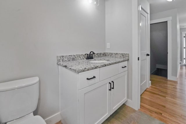 21 Stephanie St Unit 1, Gardner, MA 01440 - bathroom with toilet, vanity, wood finished floors, and baseboards