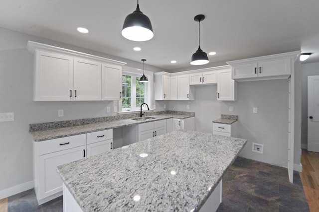21 Stephanie St Unit 1, Gardner, MA 01440 - kitchen featuring a sink, a center island, white cabinetry, light stone counters, and recessed lighting