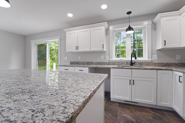 21 Stephanie St Unit 1, Gardner, MA 01440 - kitchen with a sink, healthy amount of natural light, white cabinetry, recessed lighting, and hanging light fixtures