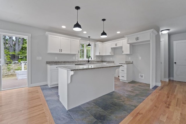 21 Stephanie St Unit 1, Gardner, MA 01440 - kitchen with a center island, white cabinetry, recessed lighting, pendant lighting, and baseboards