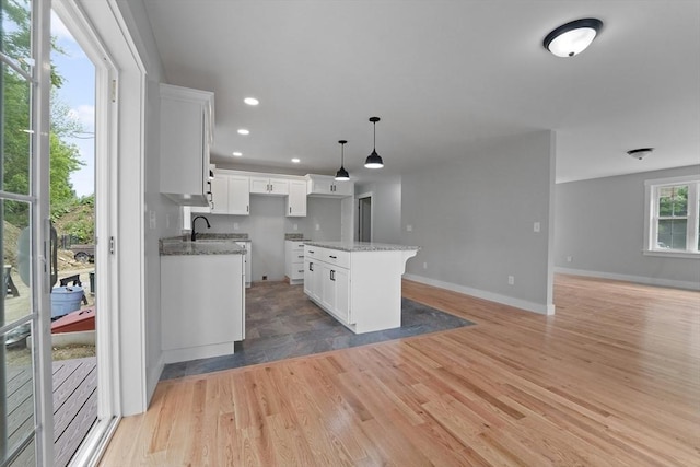 21 Stephanie St Unit 1, Gardner, MA 01440 - kitchen with open floor plan, baseboards, light wood-style flooring, a center island, and recessed lighting