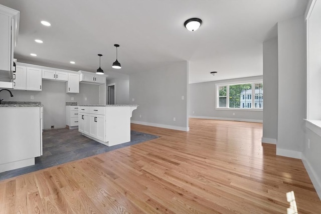 21 Stephanie St Unit 1, Gardner, MA 01440 - kitchen with open floor plan, baseboards, white cabinetry, light wood-style flooring, and recessed lighting