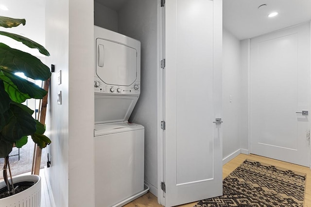340 W 2nd St Unit 23, Boston, MA 02127 - clothes washing area featuring estacked washer and dryer, light wood-style flooring, recessed lighting, and baseboards