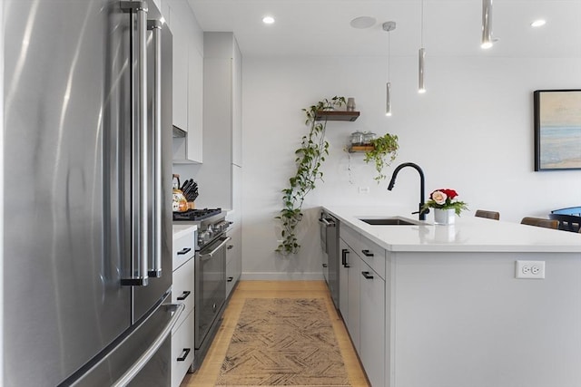 340 W 2nd St Unit 23, Boston, MA 02127 - kitchen featuring premium appliances, a sink, modern cabinets, a peninsula, and light countertops
