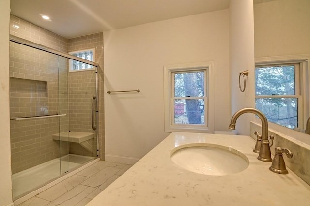 full bathroom with marble finish floor, a wealth of natural light, and a shower stall