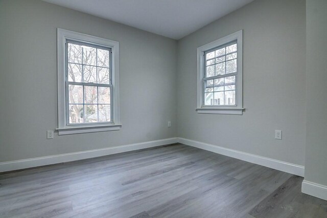 empty room featuring baseboards and wood finished floors