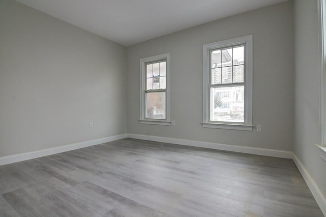 empty room featuring baseboards and wood finished floors