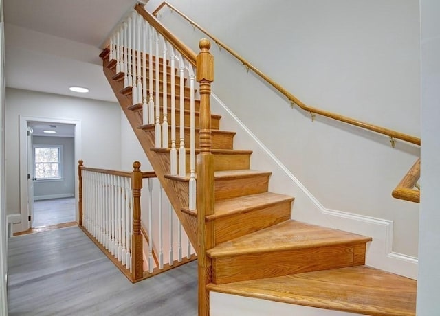 stairway with baseboards, recessed lighting, and wood finished floors