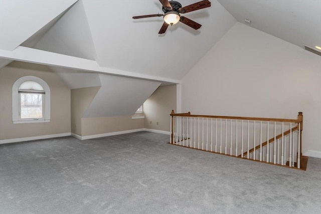 bonus room with lofted ceiling, carpet flooring, ceiling fan, and baseboards