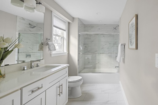 full bathroom with shower / bath combination with glass door, vanity, and toilet