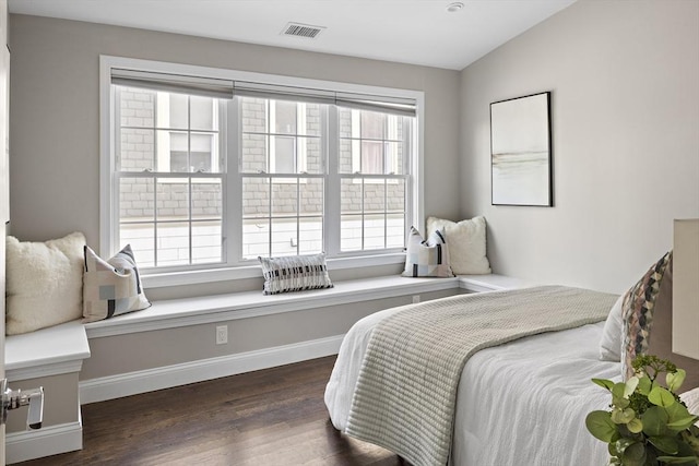 bedroom with dark wood-type flooring and lofted ceiling