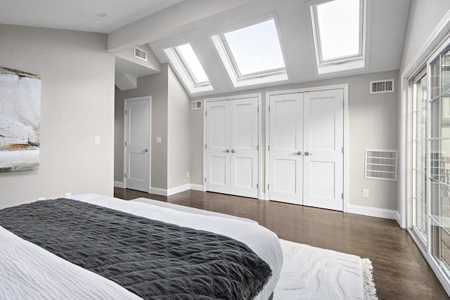 bedroom with lofted ceiling with beams, dark hardwood / wood-style flooring, and multiple closets